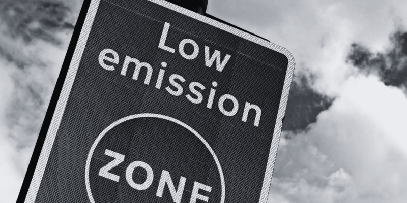 Black and white image of road sign stating low emission zone.