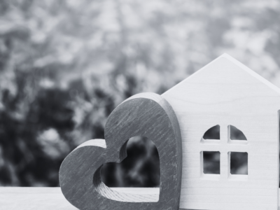 House with heart and shrubs in the background