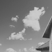 Black and white house with clouds