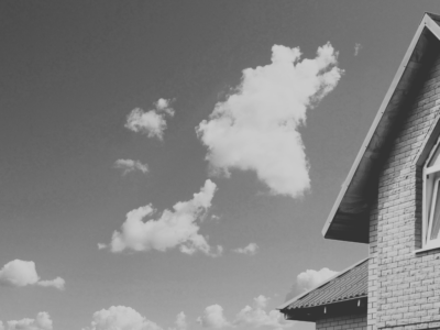 Black and white house with clouds