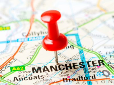 Picture of red pin in paper map on Manchester
